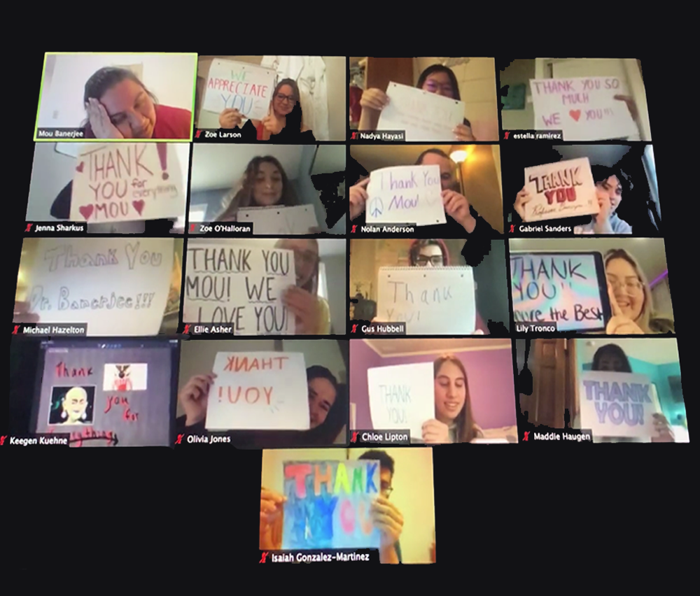 Students raising thank you banners for their teacher in a virtual online class
